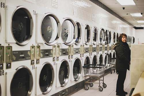 human woman in black jacket near washers laundry