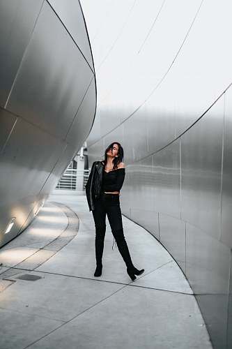 human woman in black off-shoulder dress and black pants people