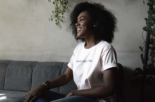 human woman smiling sitting on sofa hair