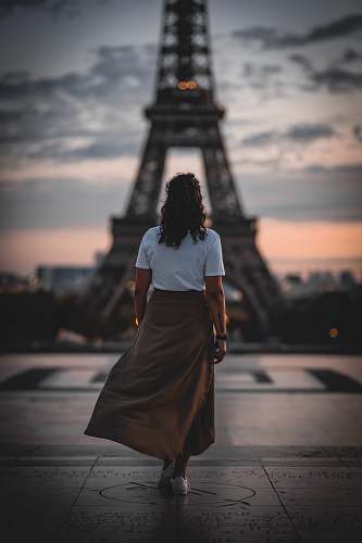 human woman standing in front of Eiffel tower people
