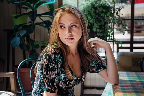 human woman wearing black and blue floral scoop-neck short-sleeved dress people