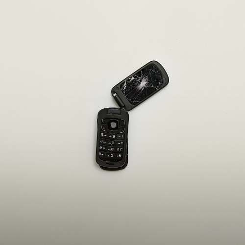 screen broken black flip phone \ isolated