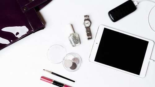 electronics silver iPad on white surface mobile phone
