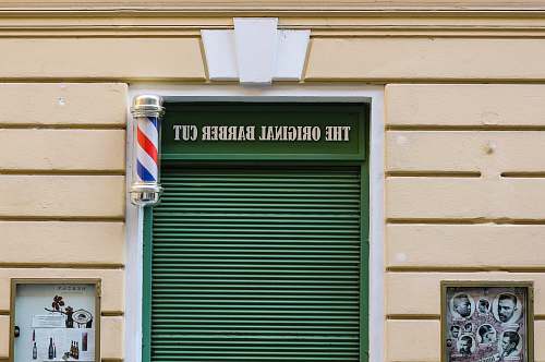czechia beige building with The Original Barber Cut sign entrance