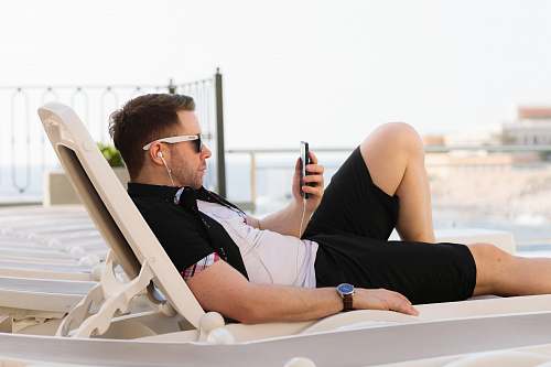 person man lying on white sun lounger human