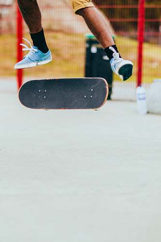 sport man playing skateboard while performing flip tricks united kingdom
