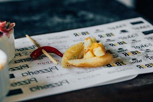 food French fries and a hot chili pepper at an Indian Restaurant cocktail stick