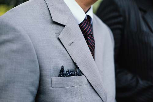 grey man wearing gray notched lapel suit jacket standing overcoat