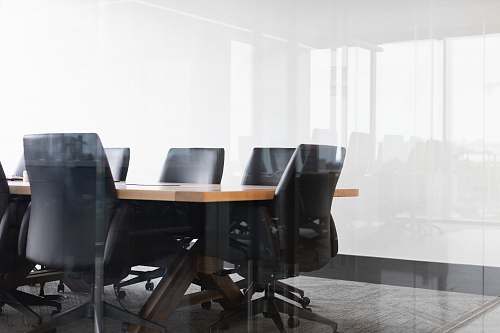 chair black rolling chairs beside brown table meeting room