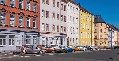 automobile assorted-color cars parked beside apartments vehicle