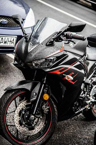 transportation black Yamaha sports bike parked on parking lot motorcycle