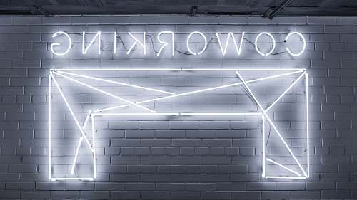 neon closeup photo of Co Working neon light sign grey