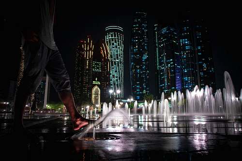 fountain water fountain in front of building during nighttime human