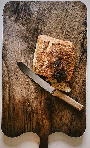 knife bread beside knife on chopping board weapon