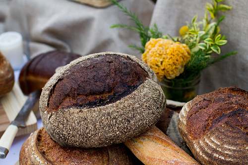 food leaven bread beside the yellow petaled flower bakery