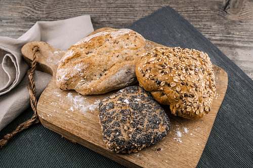 food three toasted bread on brown chopping board bakery
