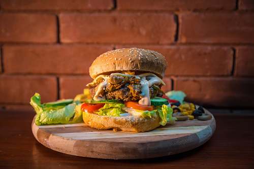 food bread with patty and sliced tomato and lettuce burger salad