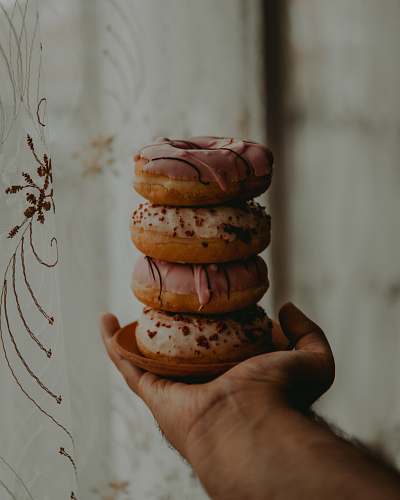 food person holding dougnuts human