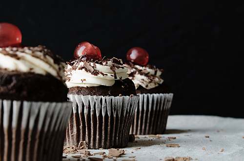cream three chocolate cupcakes with cherries cupcake
