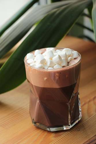 dessert chocolate with marshmallows on top in drinking glass drink