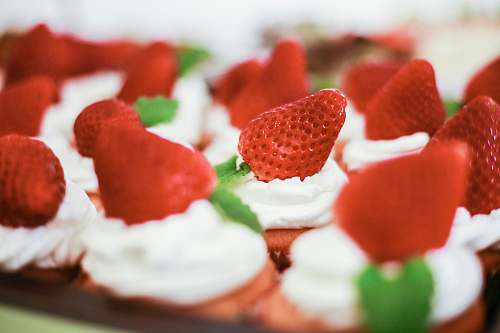 creme cupcakes with strawberries on top dessert