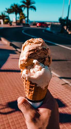 creme person holding ice cream dessert