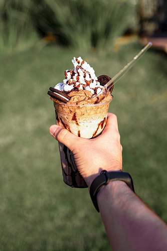 creme person holding ice cream cup dessert