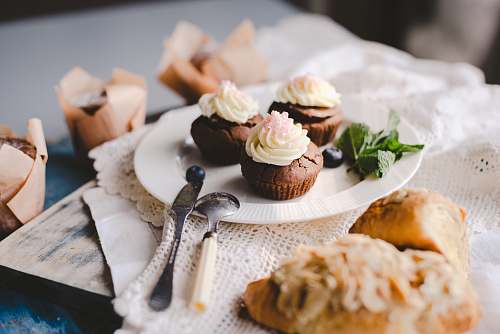 food chocolate cupcakes on white ceramic plate cream
