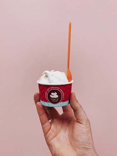 creme person holding cup of sundae cream