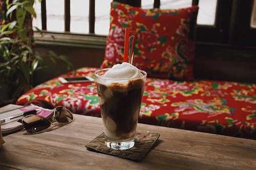 cream shake on table beside sunglasses creme