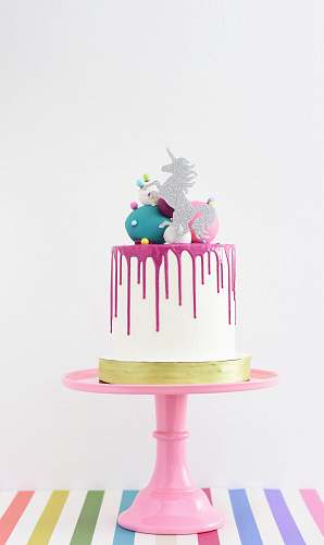 food white and pink unicorn cake on a pink stand cake