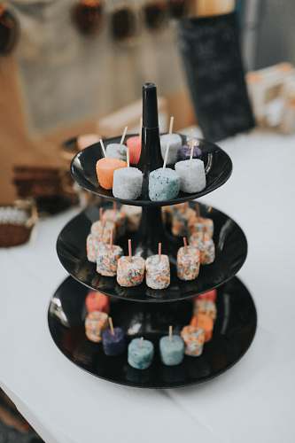 confectionery assorted color of marshmallow on black 3-tier plate sweets