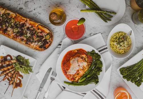 meal assorted dish on white ceramic plates pizza