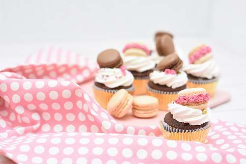 cake assorted macaroons and cupcakes on pink textile cupcake