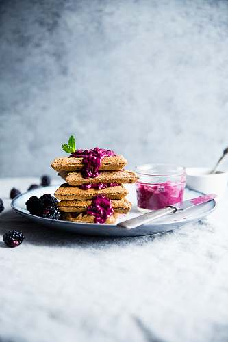 jam baked pastries near butter on white ceramic plate plate