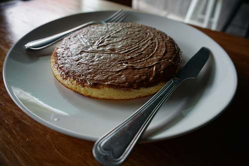 bread baked pastry with spoon and white plate pancake