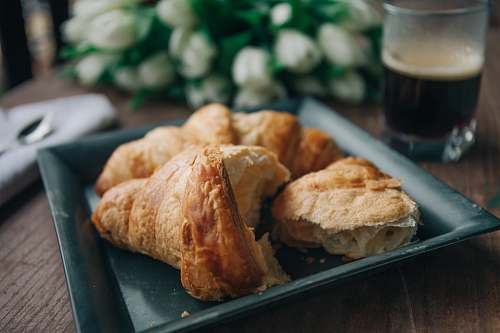 bread black ceramic tray with bread on top croissant