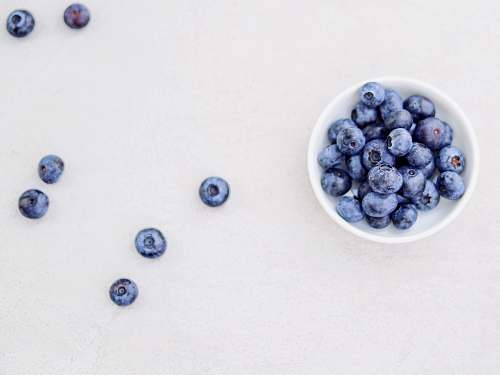 fruit blueberries in bowl and white surface blueberry