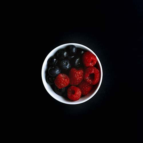 fruit blueberry and raspberry on white ceramic bowl raspberry