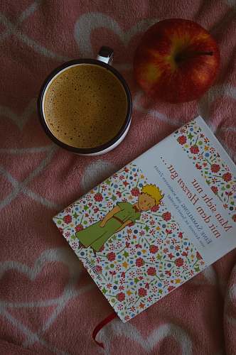 fruit book beside ceramic mug apple
