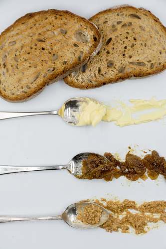 bread brown bread beside three spoons cutlery