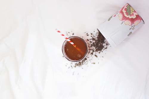 drink brown liquid with red and white straw tea