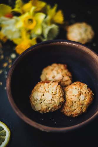 biscuits brown nuts on brown ceramic bowl flowers