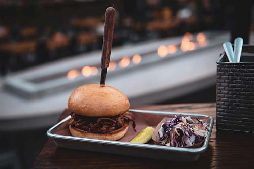 burger burger beside coleslaw on tray bread