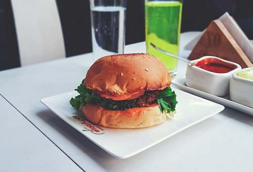 burger burger with green lettuce on white ceramic plate restaurant