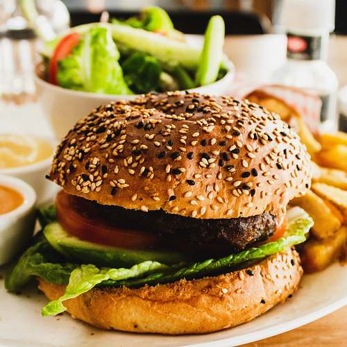 burger burger with tomato, lettuce, and fries sesame