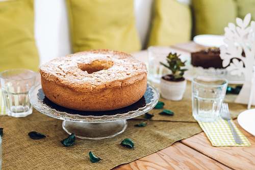bread cake on stand beside cup bagel