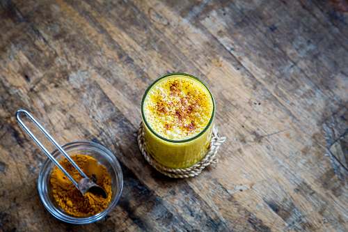 drink clear drinking glass full of orange liquid yellow