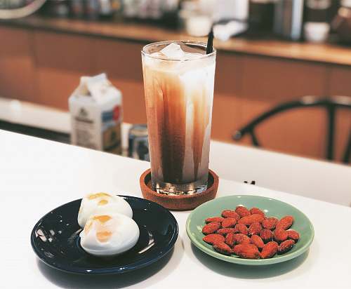 plant clear drinking glass with beside green and black ceramic plates on table egg