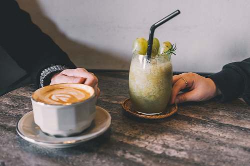fruit coffee latte beside juice glass pear